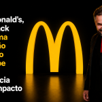 Capa 16:9 do artigo sobre a palestra de Paul & Jack para o McDonald’s, com o palestrante apontando para o público ao lado do símbolo amarelo do McDonald’s em fundo preto.