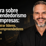 Capa de artigo em formato 16:9 com fundo escuro e detalhes dourados. À esquerda, o título “Palestra sobre empreendedorismo para empresas: como inspirar líderes, equipes e empreendedores de verdade” e a assinatura “Por Paul & Jack”. À direita, um palestrante sorrindo, em traje escuro, com elementos visuais de crescimento e gráfico ascendente ao fundo
